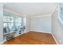 Bright living room with hardwood floors and built-in shelving beneath the windows at 4917 Melbourne Rd, Indianapolis, IN 46228