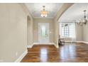 Inviting entryway featuring hardwood floors, an arched doorway, and a chandelier at 5212 Knollton Rd, Indianapolis, IN 46228