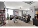 Spacious living room features comfortable furniture, decorative pillows, a glass coffee table, and neutral walls at 5453 Nighthawk Way, Indianapolis, IN 46254