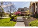 Beautiful home featuring meticulous landscaping, a walkway, and an attached garage at 553 Bolderwood Ln, Carmel, IN 46032