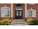 Elegant front entrance with double doors, sidelights, transom window, and brick facade at 553 Bolderwood Ln, Carmel, IN 46032