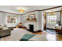 Bright living room with fireplace, wood floors, and neutral decor, showcasing a comfortable ambiance at 5611 N Delaware St, Indianapolis, IN 46220