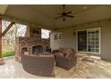 Cozy covered patio featuring a brick fireplace and comfortable seating area at 5895 Sugar Pine Dr, Avon, IN 46123