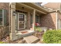 Inviting front porch with a comfortable bench and tasteful landscaping at 5895 Sugar Pine Dr, Avon, IN 46123
