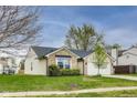 Charming single-story home featuring brick and vinyl siding, attached garage, and well-maintained lawn at 6218 Churchman Way, Indianapolis, IN 46237