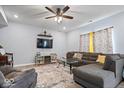 Inviting living room with plush seating, a ceiling fan, and a wall-mounted television provides a relaxing atmosphere at 6536 W Shoreline Ct, Greenfield, IN 46140