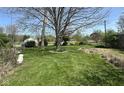 Expansive backyard featuring lush green grass and mature trees, perfect for outdoor activities and relaxation at 6622 Stanley Rd, Camby, IN 46113