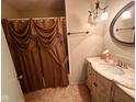 Bathroom featuring elegant vanity with marble countertop, decorative mirror and curtain at 6622 Stanley Rd, Camby, IN 46113