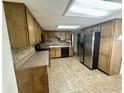 Spacious kitchen with ample wood cabinetry, stainless steel appliances, and tile flooring and backsplash at 6622 Stanley Rd, Camby, IN 46113