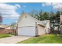 Lovely single-Gathering home with a two-car garage, brick and siding exterior, and well-maintained landscaping at 6853 Arjay Dr, Indianapolis, IN 46217