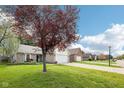 Charming one-story home in a quiet residential neighborhood with sidewalks and manicured lawns at 6853 Arjay Dr, Indianapolis, IN 46217