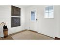 Bright entryway with white walls, wood floors, and modern decor at 7236 Estes Dr, Indianapolis, IN 46239