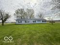 Charming single-story home with a well-maintained lawn and mature trees at 7765 N 225 W, Lebanon, IN 46052