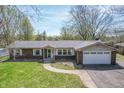A charming home with a two-car garage and a sidewalk leading to the front door at 8051 Sycamore Springs Trl, Indianapolis, IN 46239