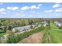 Wide aerial shot showcasing the community's layout and its proximity to nature at 8216 Glenwillow Ln # 104, Indianapolis, IN 46278