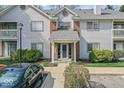 Charming front entrance with a well-maintained walkway and neatly trimmed bushes at 8216 Glenwillow Ln # 104, Indianapolis, IN 46278