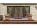 Inviting front entrance with decorative glass doors, potted flowers, and a warm, welcoming ambiance at 8901 Shetland Ln, Indianapolis, IN 46278