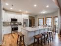 Modern kitchen featuring stainless steel appliances, white cabinetry, and a large island at 9243 Compton Farm Ln, Indianapolis, IN 46259