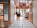 Open-concept layout showing the living room with vaulted ceilings adjacent to the kitchen at 9243 Compton Farm Ln, Indianapolis, IN 46259