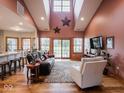Spacious living room with vaulted ceilings, large windows, and hardwood floors at 9243 Compton Farm Ln, Indianapolis, IN 46259