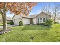 Well-manicured lawn and landscape featuring green shutters on a quaint brick and vinyl home exterior at 9688 Amber Glow Ct, Fishers, IN 46037