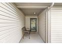 Cozy porch with neutral siding and a metal bench near the front door at 9688 Amber Glow Ct, Fishers, IN 46037