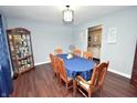 Elegant dining room featuring a classic chandelier, wood floors, and a display cabinet for showcasing collectibles at 1000 Riverview Dr, Martinsville, IN 46151