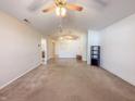Spacious living room featuring neutral walls, carpet flooring and a ceiling fan at 10822 Cape Coral Ln, Indianapolis, IN 46229