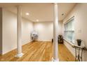 Finished basement with hardwood floors, decorative columns, and natural light at 11905 Kelso Dr # 3, Zionsville, IN 46077