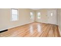 Bright living room with gleaming hardwood floors and plenty of natural light from large windows at 1231 Nester St, Speedway, IN 46224