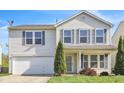 Traditional two-story home boasts green lawn, complementary landscaping, and an attached garage at 12704 Bearsdale Dr, Indianapolis, IN 46235