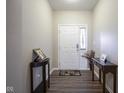Inviting entryway with hardwood floors and decorative console tables at 1299 W Crystal Dr, Fortville, IN 46040