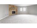 Bright and spacious living room with neutral carpet, fireplace and large windows at 2141 Rome Dr # Apt B, Indianapolis, IN 46228