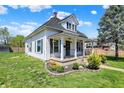 Charming two-story home with white siding, blue shutters, covered front porch and manicured yard at 222 Raines St, Plainfield, IN 46168