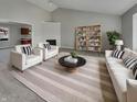 Bright living room featuring modern furniture, vaulted ceilings, a fireplace, and an open floor plan at 2338 Keystone Ct, Anderson, IN 46011