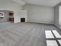 Spacious living room with neutral carpeting, a fireplace, and views to other rooms at 2338 Keystone Ct, Anderson, IN 46011