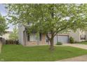 Charming two-story home with covered porch, gray siding, and a well-manicured lawn at 2348 Shadowbrook Dr, Plainfield, IN 46168