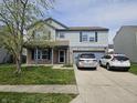 Inviting two-story home features a blend of siding and brick, covered porch, and a two car garage with driveway parking at 2348 Shadowbrook Dr, Plainfield, IN 46168