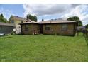 Wide view of the backyard showing well-maintained lawn and exterior of the house at 2726 S Roena St, Indianapolis, IN 46241