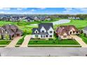 Expansive aerial view of a neighborhood with a golf course, lake and well kept lawns at 284 Chatham Hills Blvd, Westfield, IN 46074