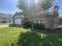 Cozy single-Gathering home with a beautiful flowering tree and a well-maintained lawn on a sunny day at 2904 Inverrary Ct, Indianapolis, IN 46234