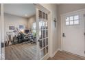 Light filled entryway with french doors leading to a home office and durable wood-look flooring at 3235 Myrtle Dr, Lapel, IN 46051