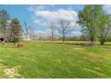 Expansive backyard featuring a large grassy area, mature trees, and potential for outdoor activities and relaxation at 3362 E Sycamore Ln, Mooresville, IN 46158