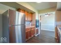 Functional kitchen featuring stainless steel appliances, wooden cabinetry, and an open layout for easy movement at 3362 E Sycamore Ln, Mooresville, IN 46158