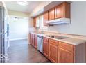 Functional kitchen with stainless steel appliances, wooden cabinetry, and view to eat in area, ready for meal preparation at 3362 E Sycamore Ln, Mooresville, IN 46158
