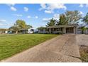 Exterior home shot including the driveway and well maintained lawn at 3561 Winings Ave, Indianapolis, IN 46221