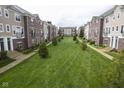 Well-manicured townhome community with lush green spaces and tree-lined walkways creating a serene environment at 360 Neuman Way, Carmel, IN 46032
