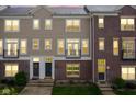 Inviting townhome featuring a mix of brick and siding, complemented by black trim and a charming balcony at 360 Neuman Way, Carmel, IN 46032