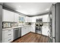 Modern kitchen with stainless steel appliances, white cabinets, and granite countertops at 3615 Dawnwood Dr, Indianapolis, IN 46227