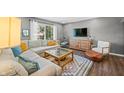 Cozy living room featuring a comfortable sectional sofa and large window with natural light at 3615 Dawnwood Dr, Indianapolis, IN 46227